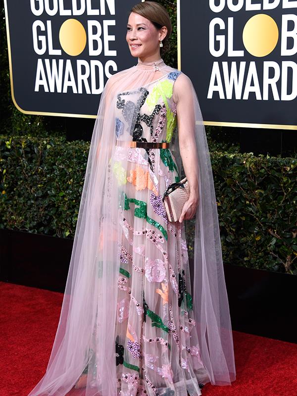 Actress Lucy Liu (who seems to never age), appears to be wearing a Grecian style kids drawing and cape.
