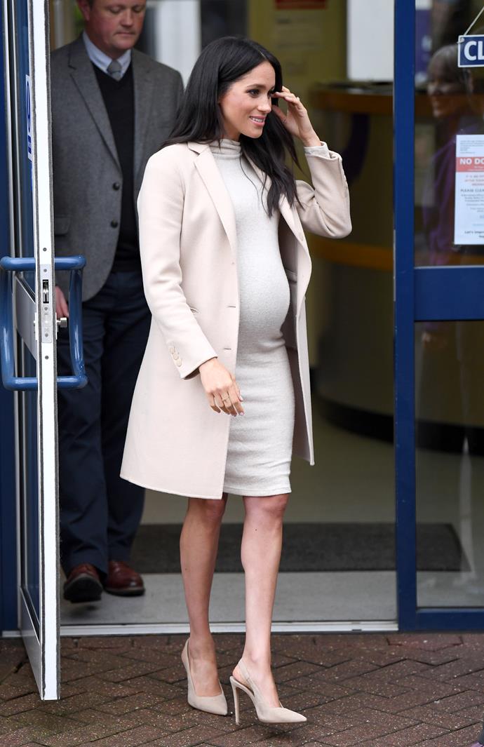 Duchess Meghan's monochrome beige outfit looked stunning on the pregnant royal. *(Image: Getty)*