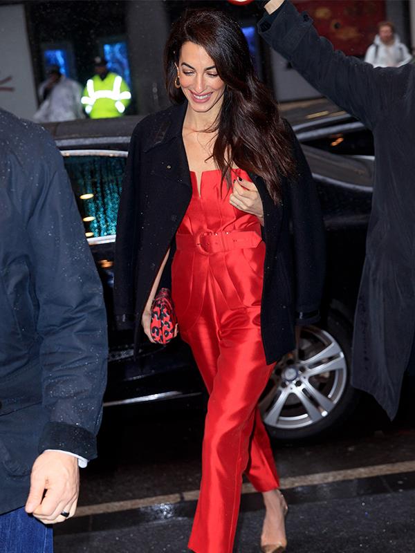 Red Hot: Amal Clooney brought some brightness to Meghan's baby shower. *(Image: Getty)*