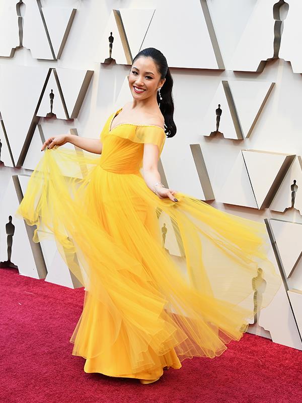 Shining in sunshine yellow, *Crazy Rich Asians*' Constance Wu has brought some colour to the red carpet in a Atelier Versace dress.