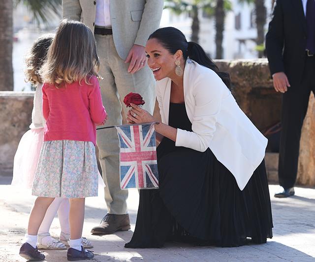 The two young girls presented the royals with flowers. *(Image: Getty)*