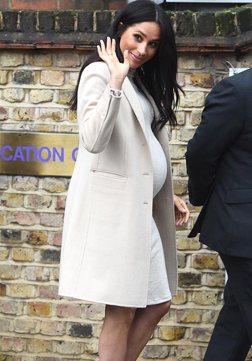 Pregnant Meghan looked cosy and chic in this Emporio Armani pea coat. *(Image: Getty)*