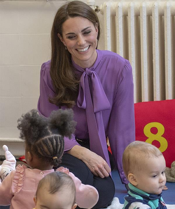 A mum-to-three, Kate looked at home with the children at the centre. *(Image: Getty)*