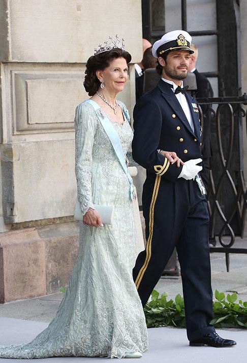 A queen and her son: Queen Silvia of Sweden and Prince Carl Philip at the wedding of Princess Madeleine of Sweden in 2013.