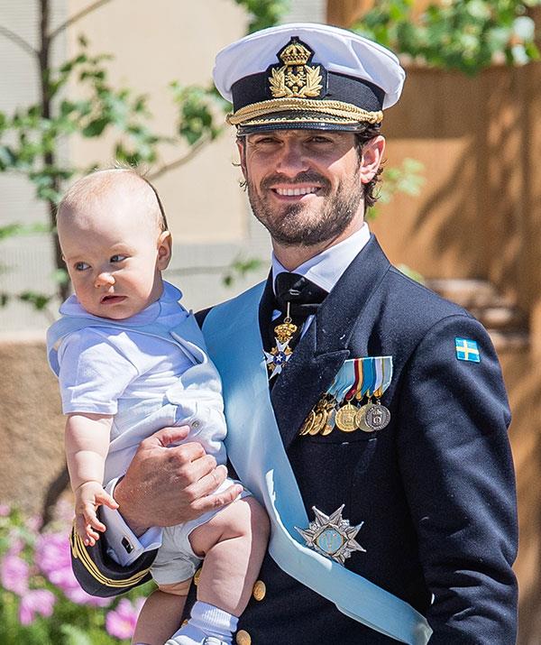 A uniformed royal with his babe in arms... We have no words.