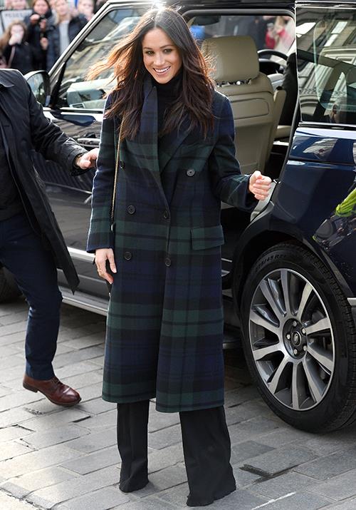 Meghan is giving us every reason to wear more tartan. *(Image: Getty)*