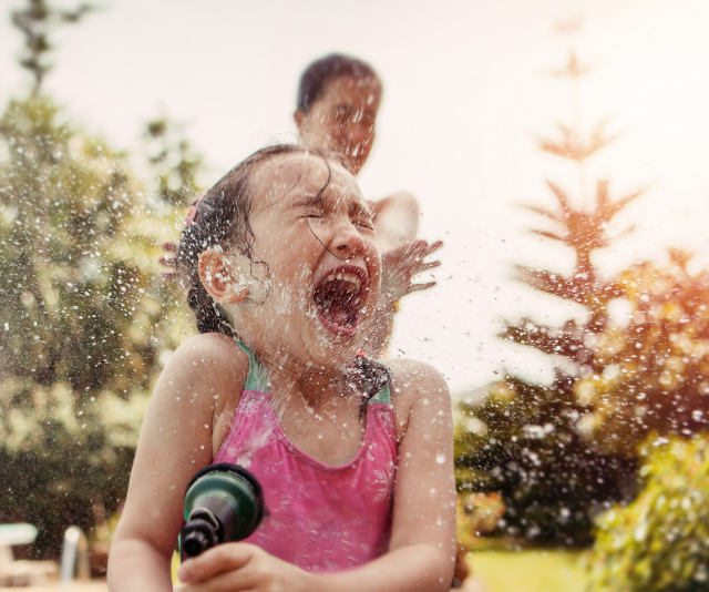 **Water play:** While hitting a backyard with the hose or a sprinkler is great fun, even a small waterplay table set up on a balcony will keep kids entertained and cool in the summer holidays. Buckets, tubs, cups, colanders, water balloons, ice and sponges make great props. Remember to always supervise kids around water. *Image: Getty.*