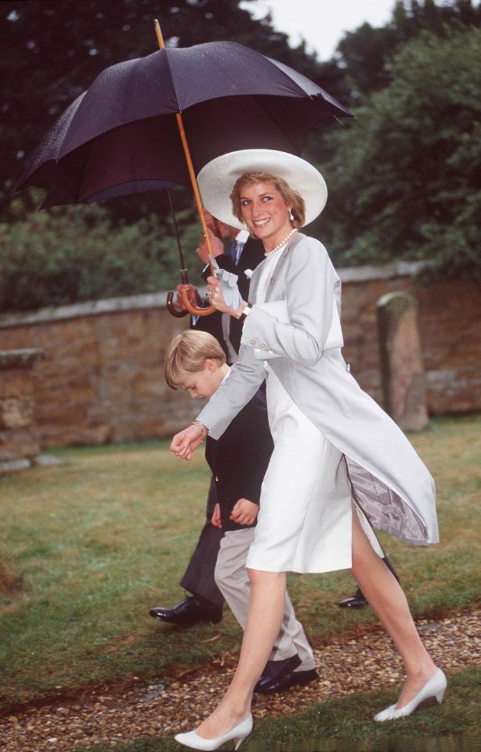 The gorgeous Princess Diana didn't let the rain bother her! Here she is striding with confidence on a drab British day. *(Image: Getty)*