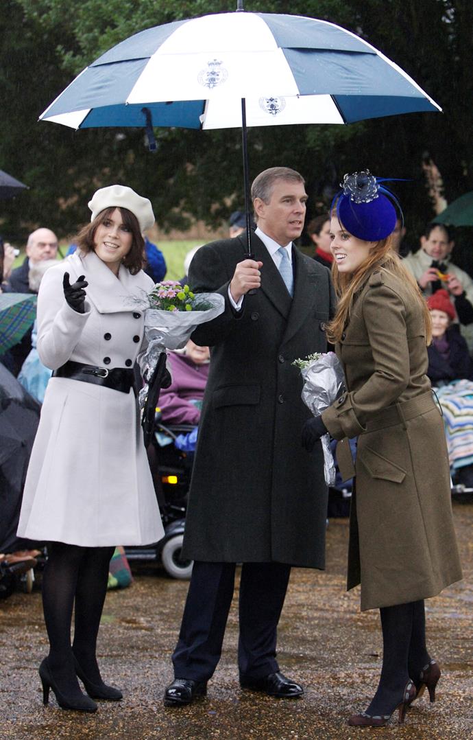 Princess Eugenie, Princess Beatrice and their father Prince Andrew keeping dry during the royal family's traditional Christmas service at Sandringham. *(Image: Getty)*