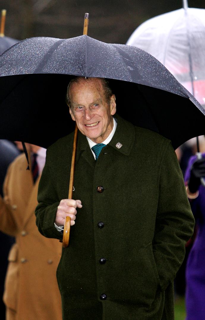 He might be pushing 100, but Prince Philip can still do pretty much everything on his own, including keeping himself out of the rain. *(Image: Getty)*