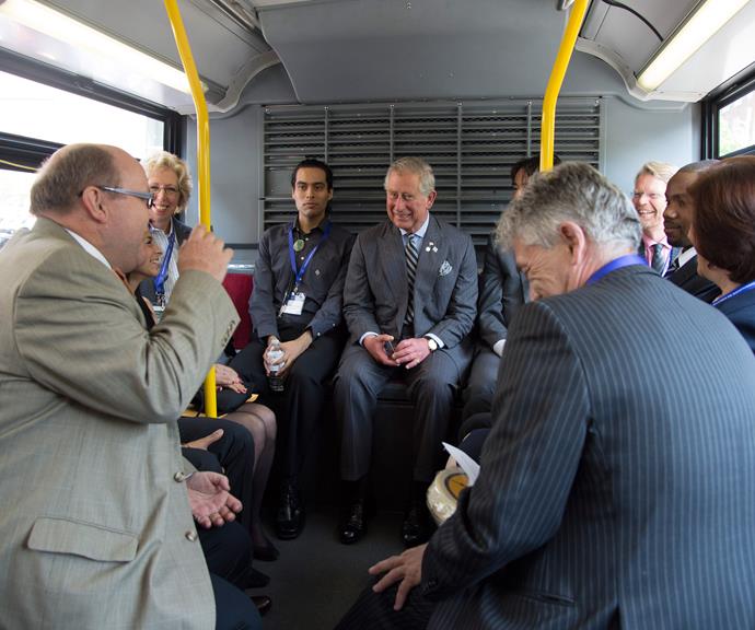 Prince Charles chats with members of the public on the bus. *(Image: Getty)*