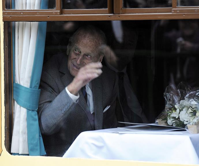 Prince Philip waving to fans while aboard the Royal Train in Scotland, 2015. Yep, the royal train is totally a thing! The train is used to transport senior members of the royal family around Great Britain. *(Image: Getty)*