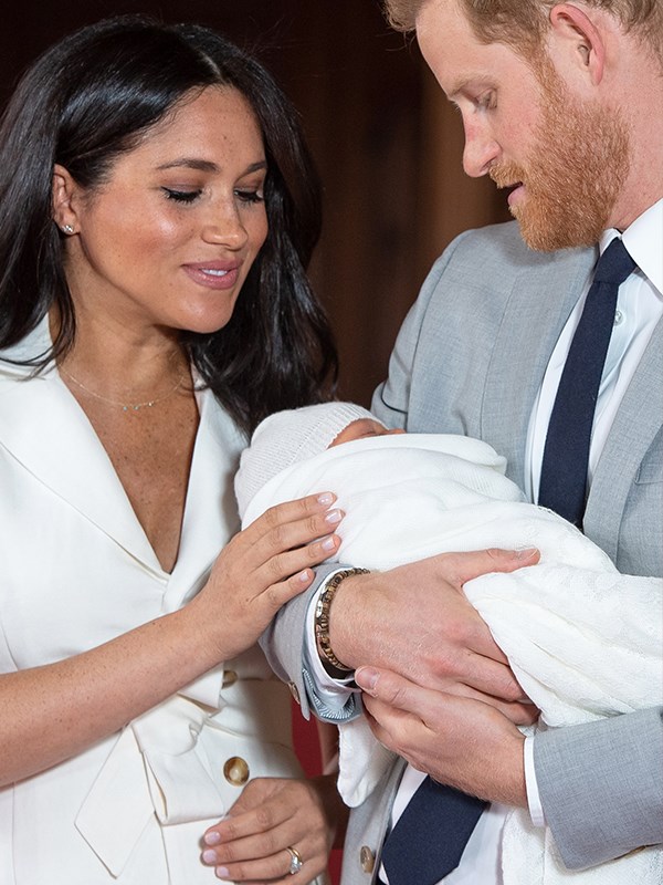 Little Archie's parents The Duke and Duchess of Sussex dotes over him. *(Image: Dominic Lipinski / PA / Getty)*