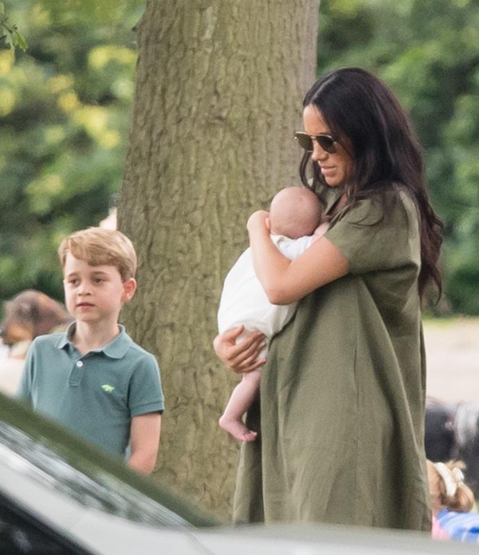 Here she is! Meghan looked chic in a khaki dress and chic sunglasses, while baby Archie cosied up to her!