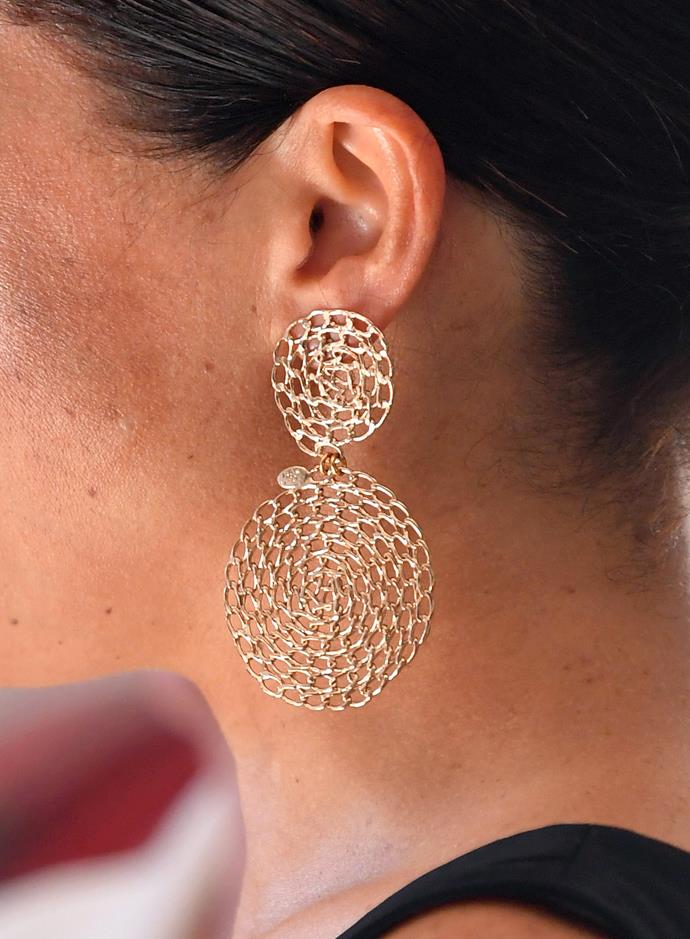 The Duchess of Sussex kept her hair tied back in a neat bun and sported a pair of stunning gold earrings by GAS Bijoux.