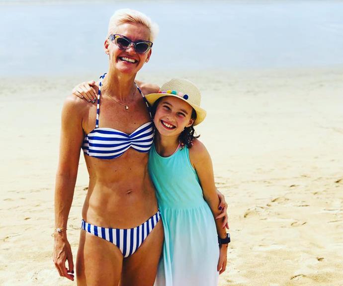 Jess and her daughter at the beach. Look at those abs!