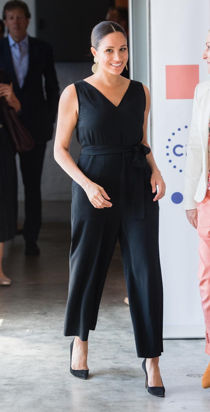 In September, Meghan kick-started another heavenly fashion spectacle as she [toured South Africa](https://www.nowtolove.com.au/royals/british-royal-family/meghan-markle-africa-fashion-58378|target="_blank") with Prince Harry and baby Archie. In one of our favourite looks from the tour, Meghan turned heads in this chic sleeveless black jumpsuit by Everlane.