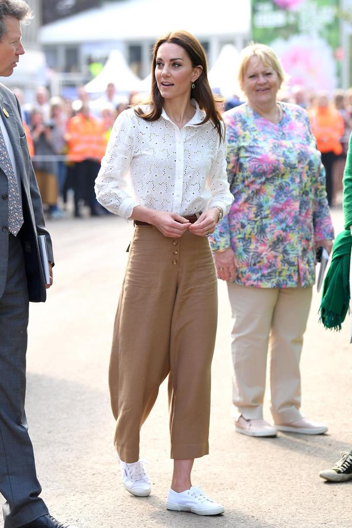 Kate oozed cool girl chic as she stepped out to help reveal her Chelsea Flower Show garden in this chic white embroided shirt, brown culottes and *those* [Superga sneakers](https://www.nowtolove.com.au/fashion/fashion-news/kate-middleton-sneakers-55859|target="_blank"). Nailed it!
