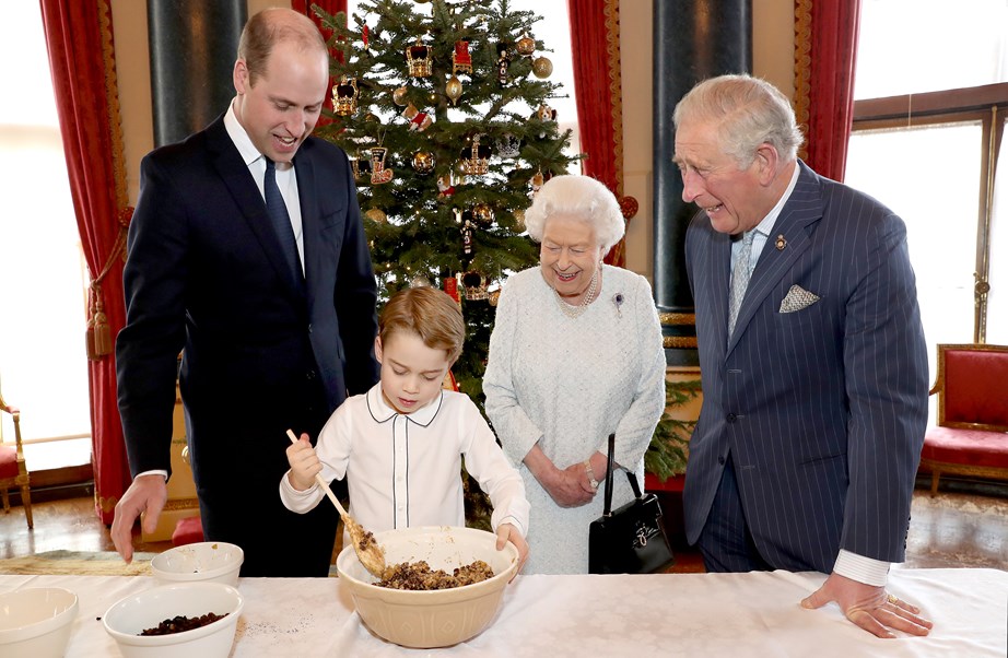 Prince George gets stuck into the fruity mix of a Christmas pud and he looks like a pro already! *(Image: Getty)*