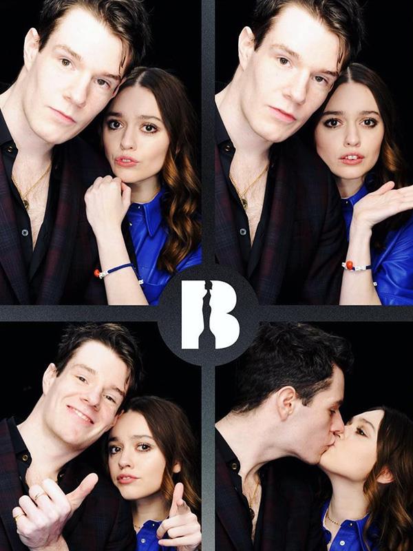 Posing together in a photobooth.