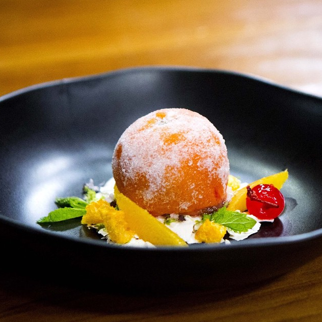For one of the invention tests, Reynold whipped up a candied clementine skin filled with blood orange and lime sorbet, coated in sugar on a bed of meringue with orange segments and candied cherry with some flambeed whiskey on top.