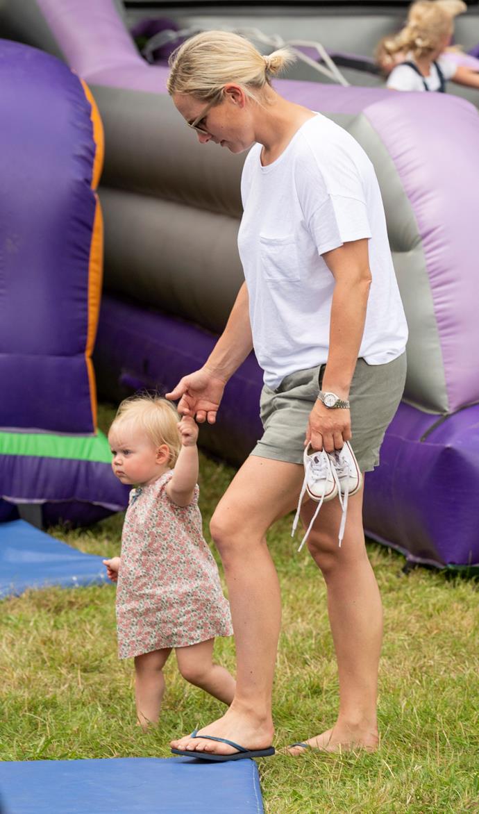 Little Lena was alert as ever with the helping hand of Mum at another fete event that same year.