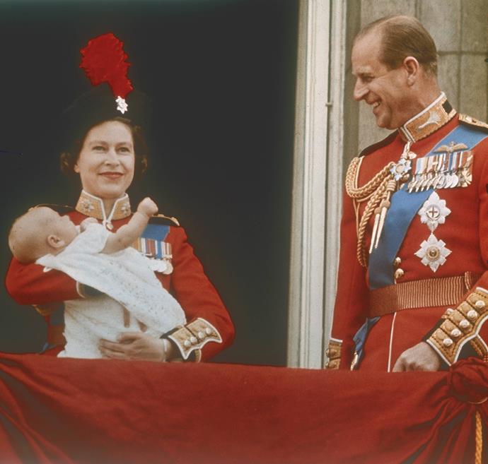 A royal spectacle indeed. In 1964, the Queen set the precedent for the annual event by wearing official garb like her husband Philip. In the above picture, she holds newborn son Prince Edward.