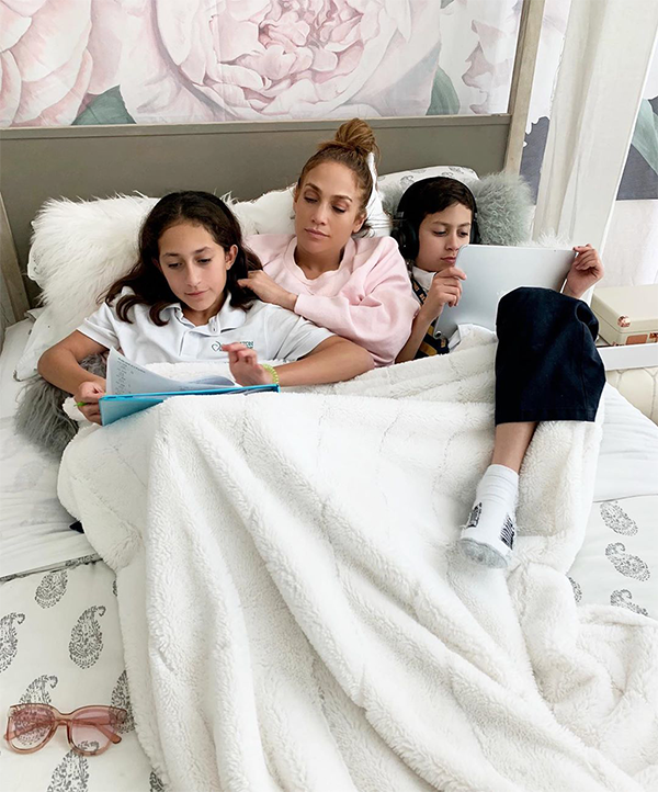 J. Lo and her twins Emme Maribel and Maximillian David relaxing in bed together.