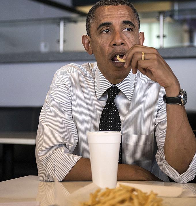 An iconic picture of Obama eating chips.