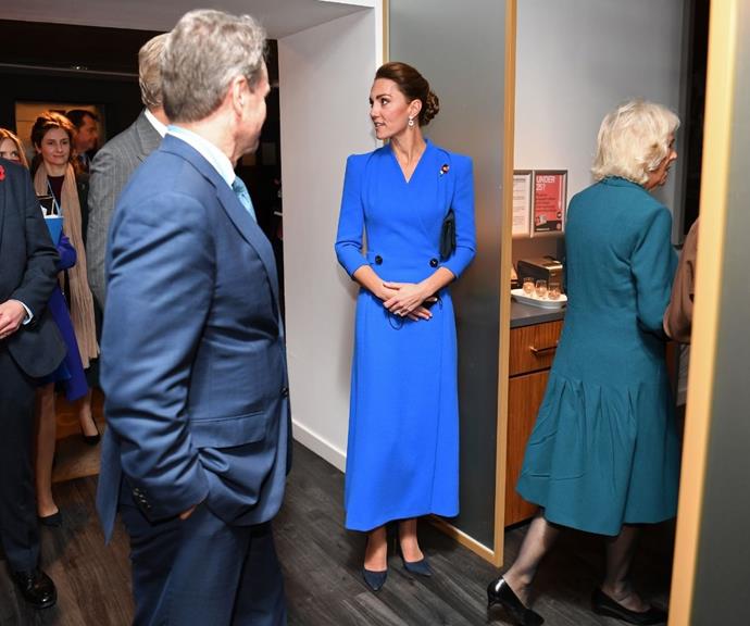 Catherine styled her electric blue outfit with sleek navy-blue pumps, with her hair placed in a meticulous up-do.