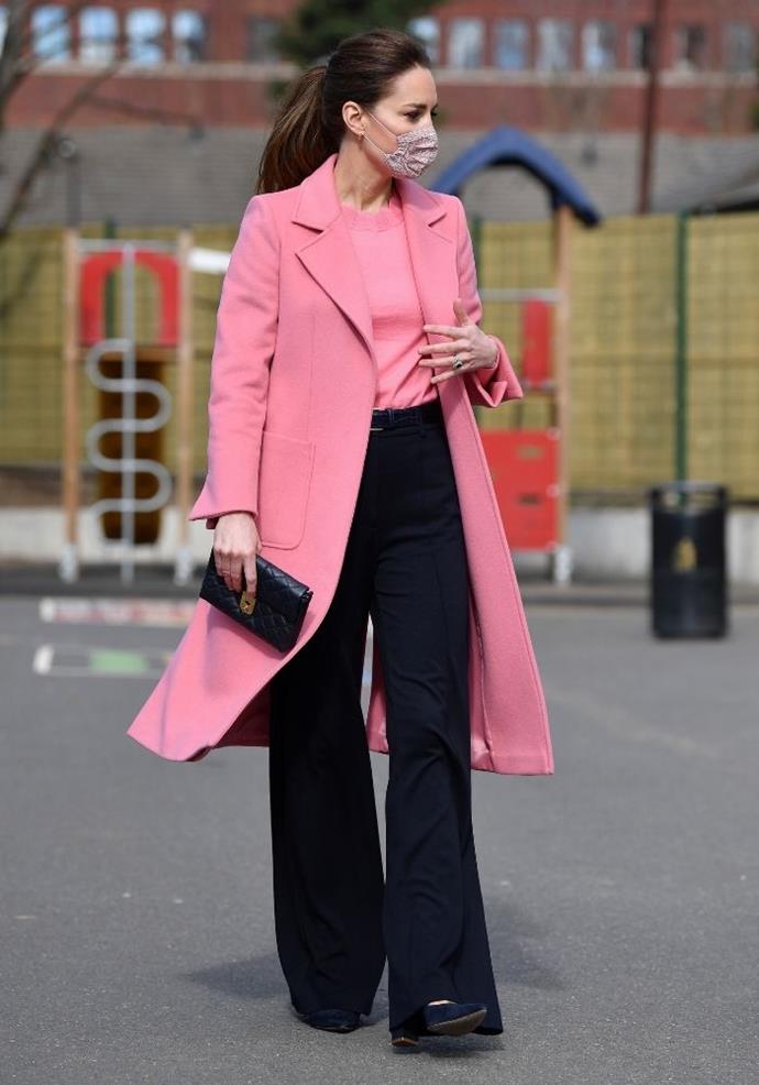 To visit a school in Stratford in 2021, Kate matched her shirt to her coat, contrasting well with her black pants and clutch.
