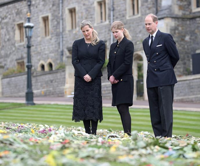The trio were solemn as they viewed hundreds of flower tributes left for the Duke of Edinburgh.
