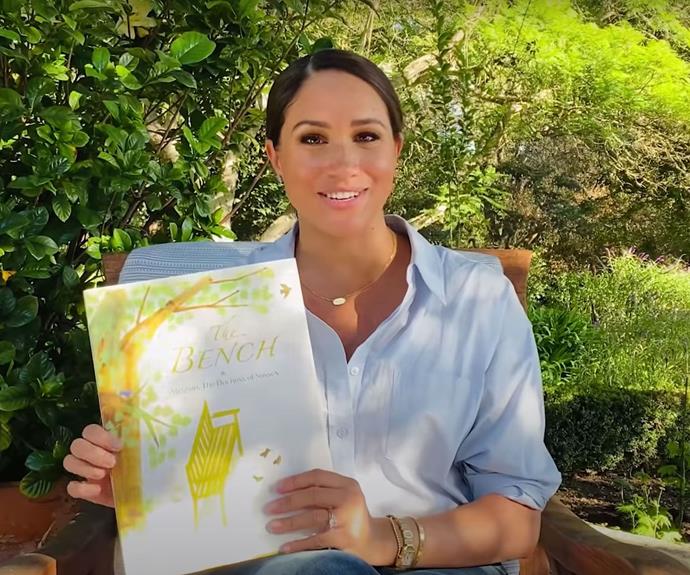 Nothing beats a classic white shirt and jeans! The Duchess of Sussex kept things casual to read her book *The Bench*.