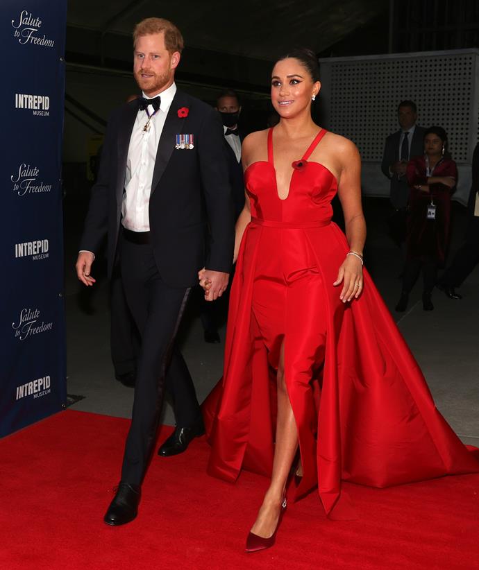 **November 2021: The red dress that broke the internet**
<br><br>
The couple left the world's jaws agape when they made a surprise appearance at the 2021 Salute To Freedom Gala at the Intrepid Sea-Air-Space Museum to mark Remembrance Day known as Veterans Day in the US. Meghan stunned in her crimson Carolina Herrera gown as she walked in hand-in-hand with her prince.
