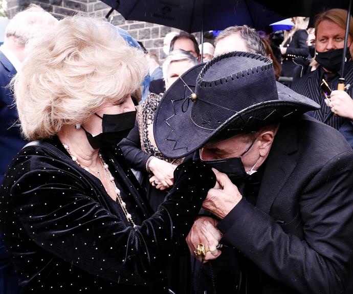 Molly Meldrum gives Patti a kiss on the hand after the moving service.