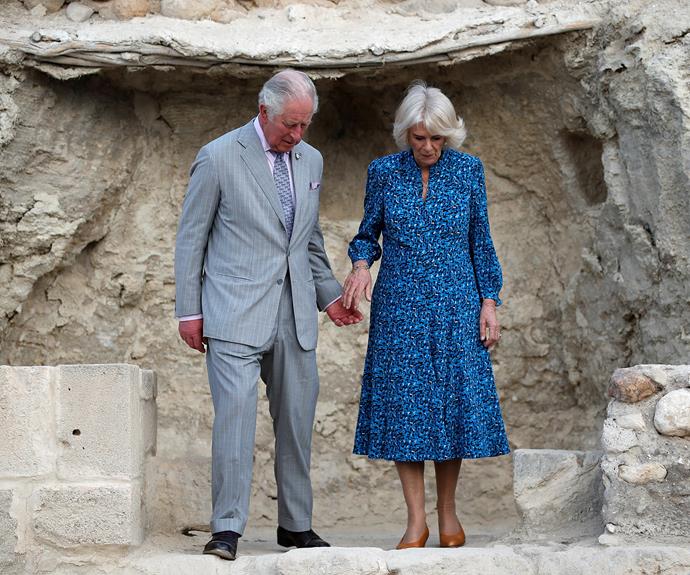 Charles was then photographed [taking Camilla's hand](https://www.nowtolove.com.au/royals/british-royal-family/prince-charles-duchess-camilla-love-story-52373|target="_blank") as he helped her down the rocky stairs.