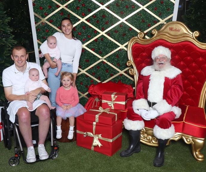 **Teigan and Alex McKinnon**
<br><br>
The young couple took their daughter Harriett and her [twin sisters Violet and Audrey](https://www.nowtolove.com.au/celebrity/celeb-news/alex-teigan-mckinnon-relationship-68119|target="_blank") to meet Santa, and Teigan proudly captioned the snap, "Merry Christmas from The McKinnons 🎄."