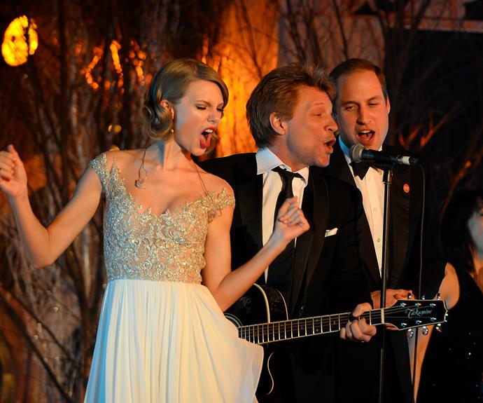 Prince William has revealed the true story behind this incredible photo of him rocking out with Jon Bon Jovi and Taylor Swift at the Centrepoint Gala Dinner at Kensington Palace in 2013. [Recalling the night on the Apple Fitness+ *Time to Walk* podcast](https://www.nowtolove.com.au/royals/british-royal-family/prince-william-george-charlotte-louis-70237|target="_blank"), the future king said: "I can't believe I'm actually telling this story." 
<br><br>
He continued: "I'm sat next to Taylor Swift, she's on my left. And after Jon does his first song, there's a pause, and she turns to me. She puts her hand on my arm, looks me in the eye, and says, 'Come on, William. Let's go and sing,'"