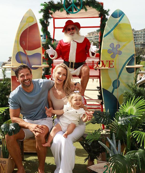 **Anna Heinrich and Tim Robards**
<br><br>
The definition of Christmas Down Under! *Bachelor* couple Anna and Tim posted this pic with their daughter Elle (and of course, Santa) in Sydney in the lead-up to the big day. 
<br><br>
"A VERY AUSSIE XMAS 🤶 🎅" the couple captioned their joint post.