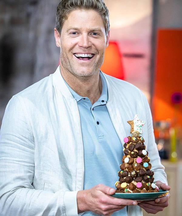 **Dr Chris Brown**
<br><br>
Australia's most beloved vet got into the Christmas spirit by making a festive-themed "Dogembouche" during an episode of *The Living Room*.
<br><br>
"Behold…my culinary life masterpiece. The (edible) Dog Christmas tree!" Chris quipped on Instagram.
<br><br> 
"Because my Dogembouche (that's a dog croquembouche…come at me *Masterchef*) is made with my Drool treat balls, it's also packed full of goodness."