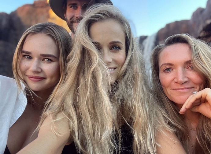 Photo bomb! Liam snuck up behind his girlfriend as she posed for a photo with friend Michele Merkin and Liam's sister-in-law, Samantha Hemsworth.