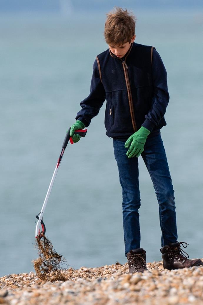 The Queen's youngest grandchild pictured cleaning the beach.