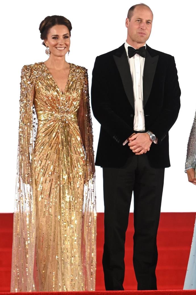 The Duchess pulled off one of the most noteworthy red carpet moments of 2021 when she showed up to the James Bond movie *No Time to Die* premiere in this gold Jenny Packham dress. Its embroidered cape and architectural shoulders are one of her boldest looks and most successful gowns.