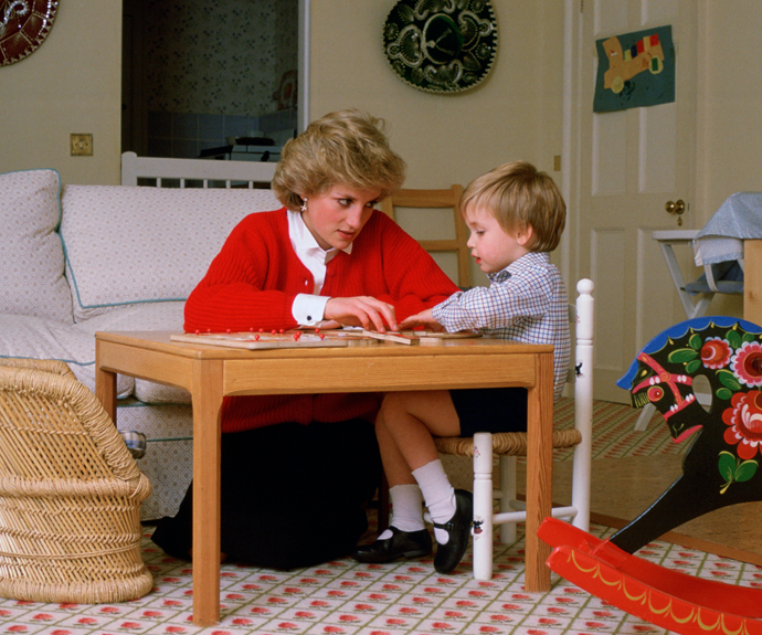 Princess Diana sits playing with a young Prince William at Kensington Palace.