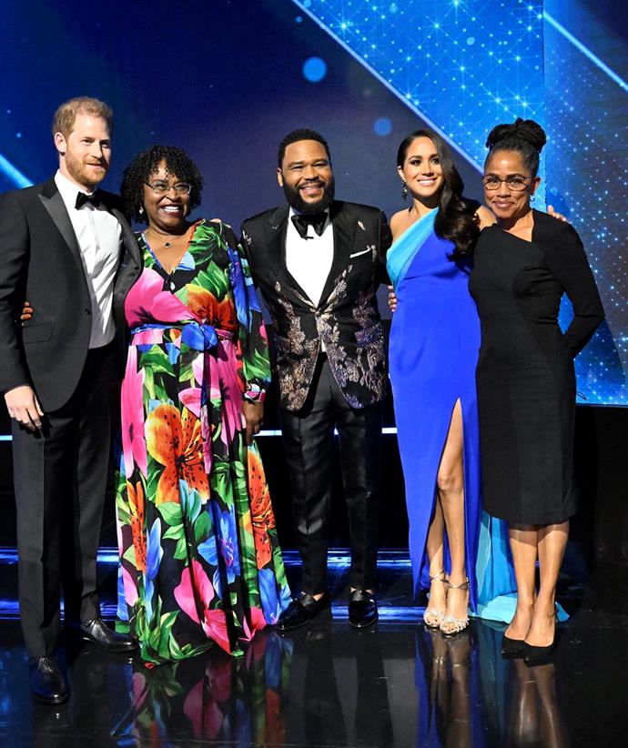 The couple brought Meghan's mother Doria Ragland (far right) on stage at the awards show.
