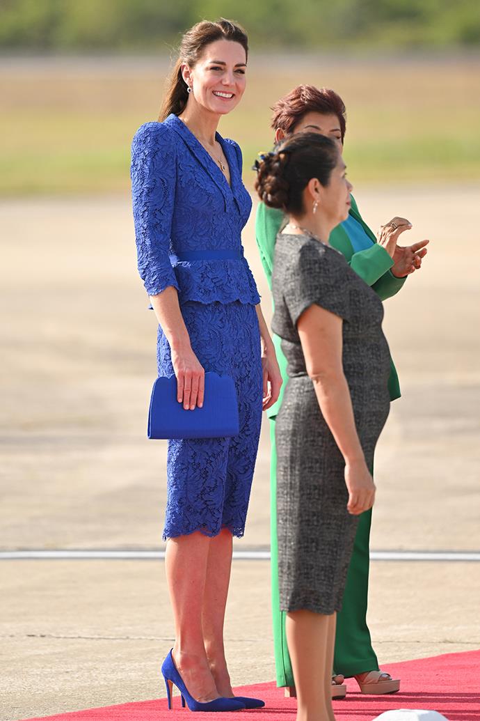 The royal wore a bespoke Jenny Packham lace peplum dress, paired with a matching set of Emmy London 'Rebecca' suede pumps and a scalloped clutch. Her colour choices may be a nod to the royal blue of the Belizean flag.