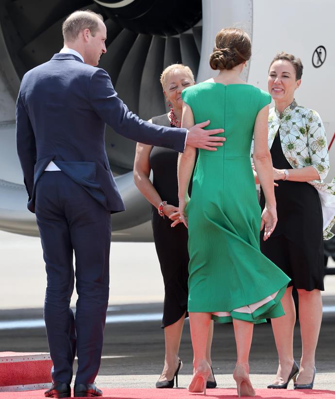 William placed a reassuring hand on his wife's back as they headed onto a plane in Jamaica.