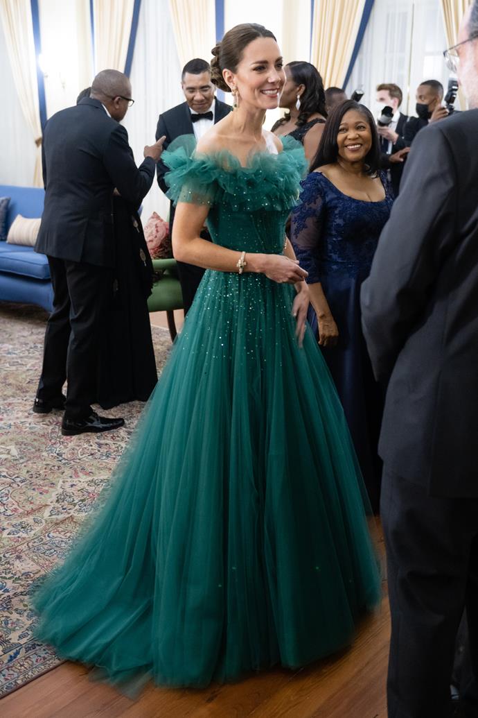 Attending a dinner in Jamaica in March 2022, Catherine stole the show in [this floating green tulle number featuring a cinched waist](https://www.nowtolove.com.au/royals/british-royal-family/kate-middleton-green-dress-jamaica-71545|target="_blank"), rhinestone details and a delicate off-the-shoulder neckline. The full princess-style skirt fell elegantly to the floor and trailed behind her, making headlines as she looked more regal than ever.