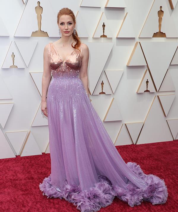 Jessica Chastain wore a stunning lilac purple Gucci gown to attend the Oscars, where she is up for best actress for her role in *The Eyes of Tammy Faye*.