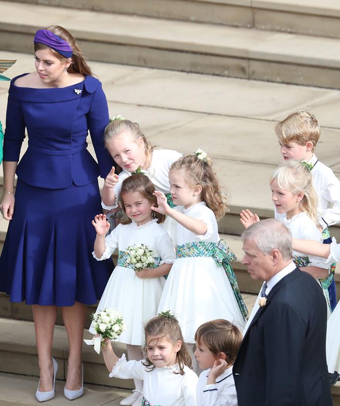 Princess Beatrice stands with flower girls and page boys - including George and Charlotte - at Princess Eugenie's 2018 wedding.